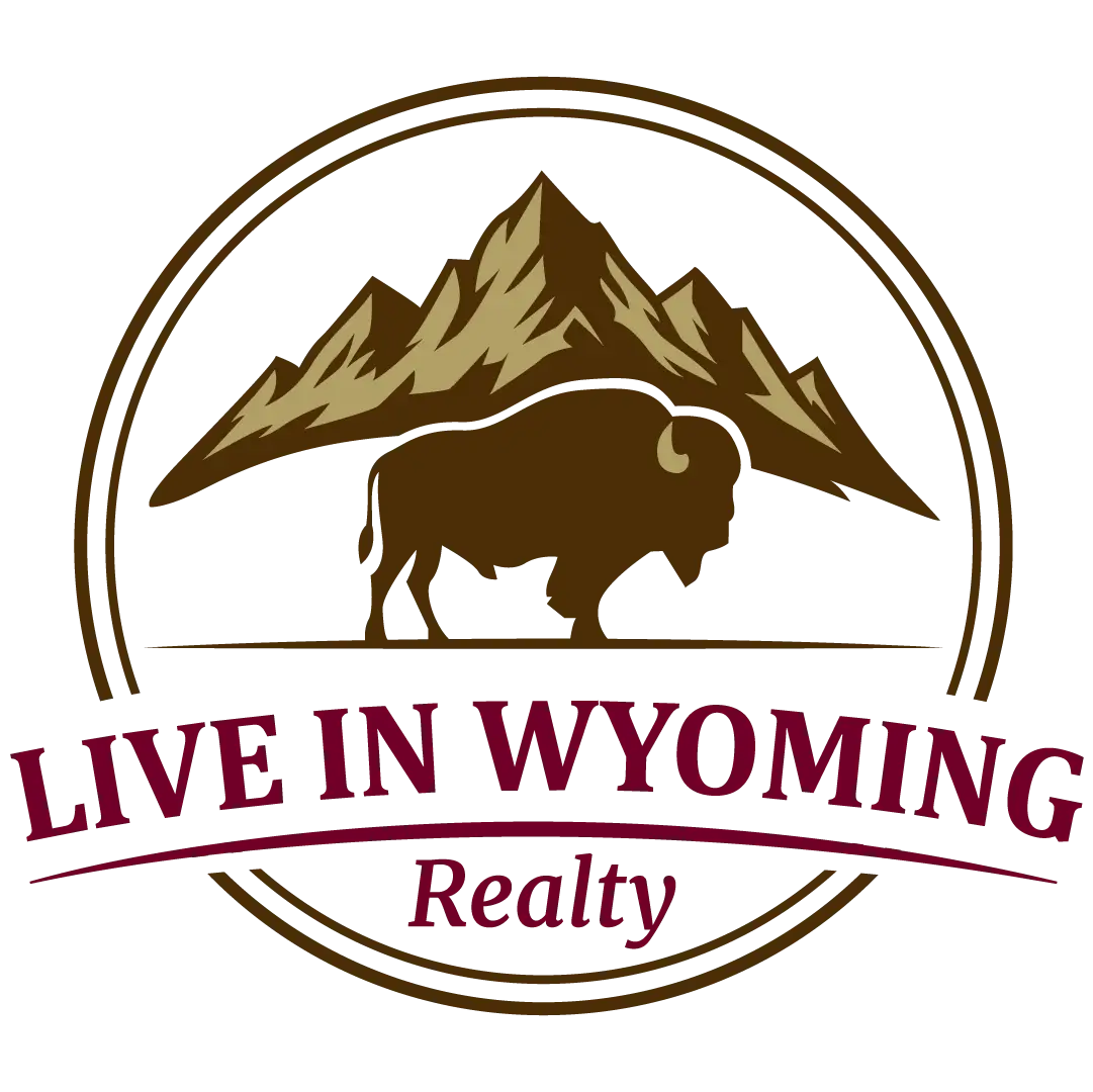“Live in Wyoming Realty” logo with mountains and a bison inside a circular badge, maroon and brown color scheme on a transparent background.